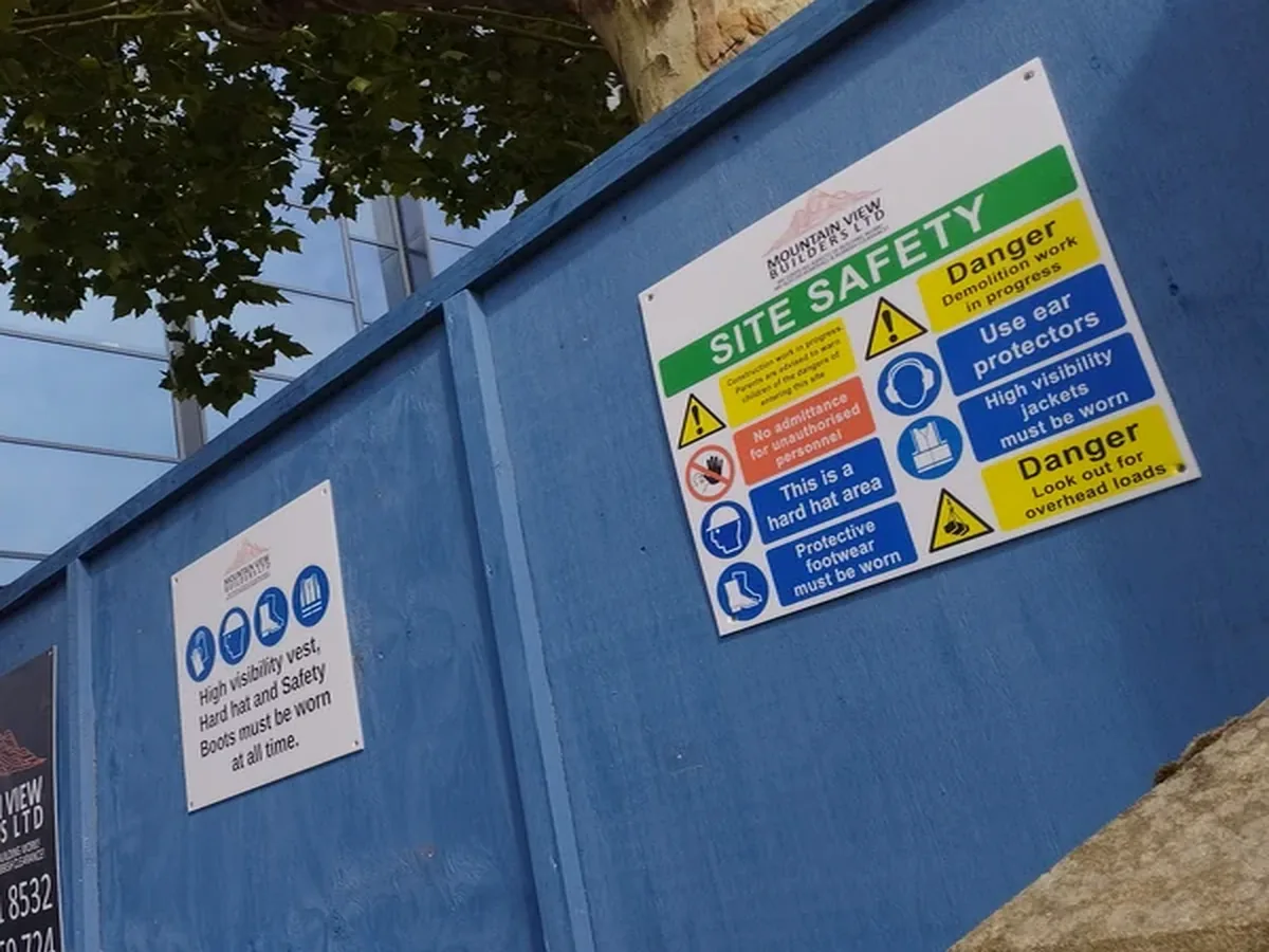 Site safety signage on controlled construction hoarding
